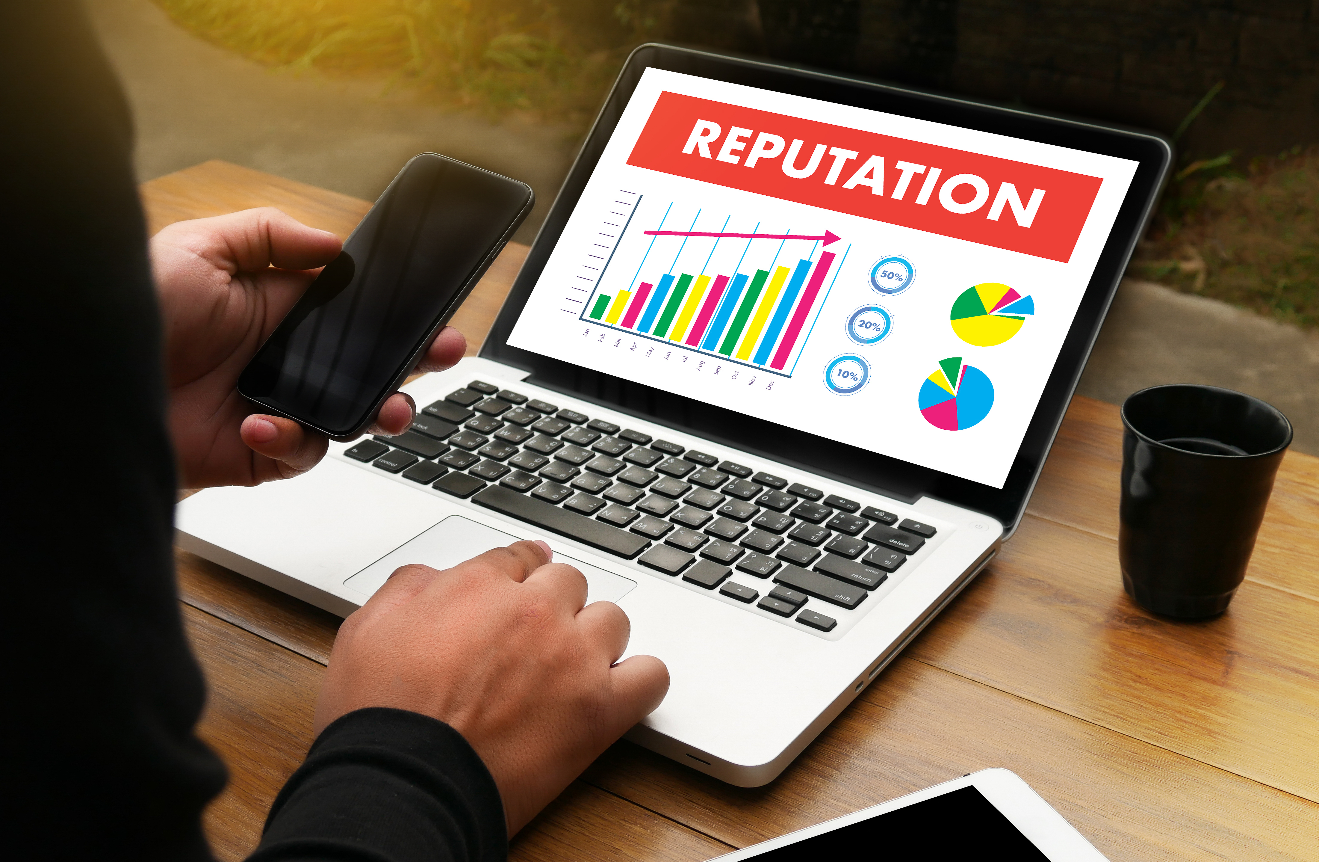 Person managing online reputation on laptop