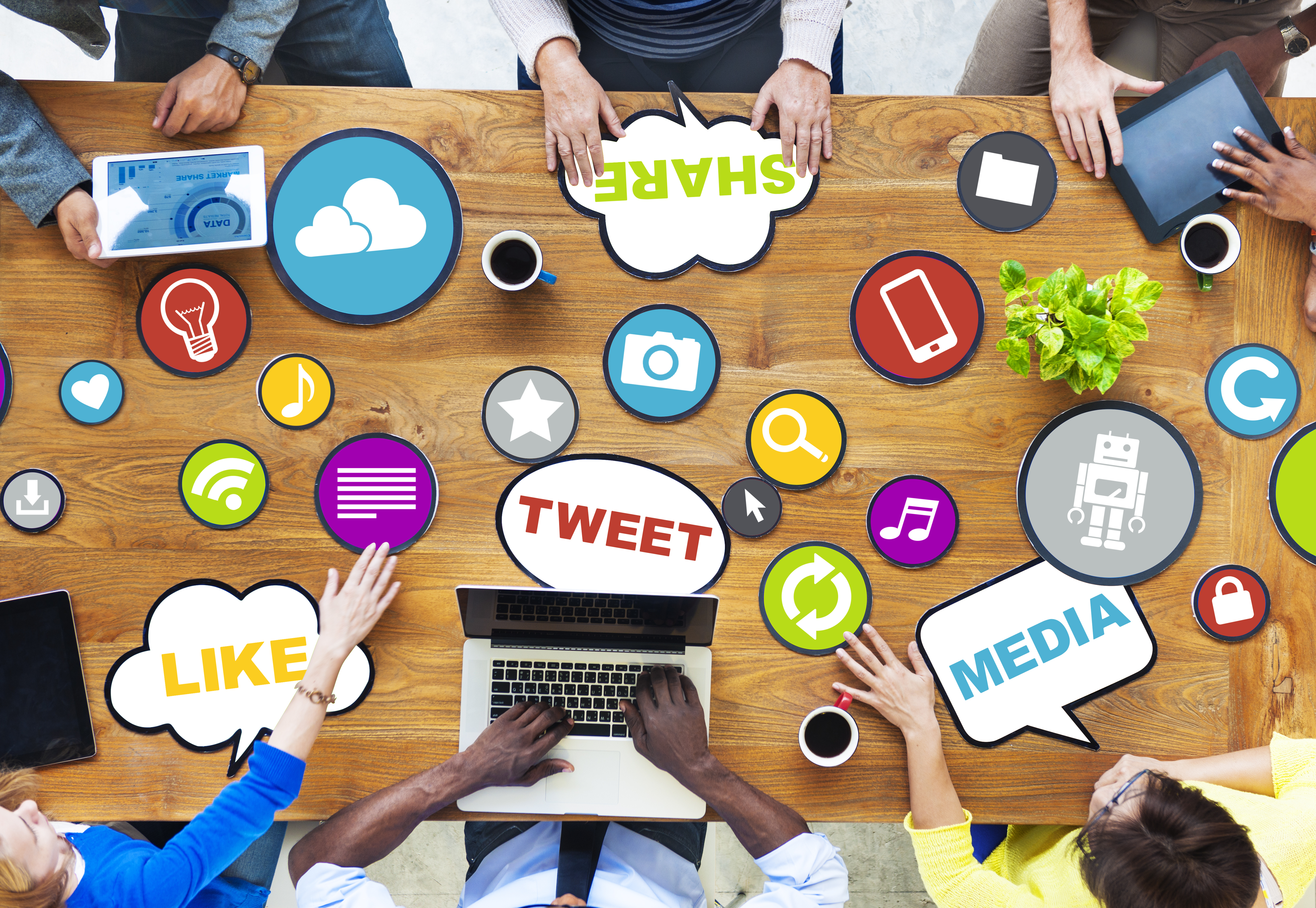 People around table exchanging social media marketing ideas